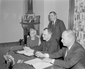 Ruth Bagley sitting at a table with other faculty members