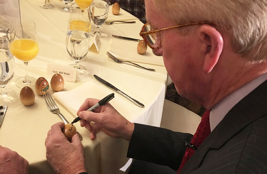 Bill Weld signing wooden egg