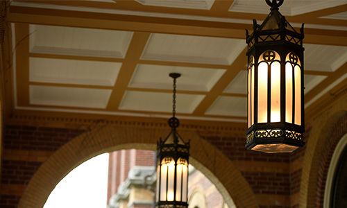 Outdoor light fixtures of Alumni Hall illuminated 