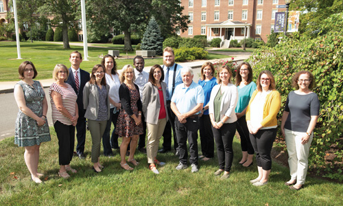New faculty members pose in front of the upper quad