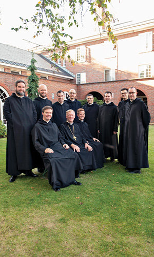 monks pose together outside of the abbey