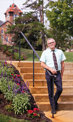 Dan Forbes in front of alumni hall stairs