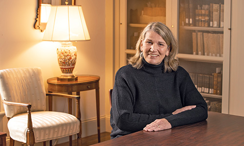 woman sits at a desk