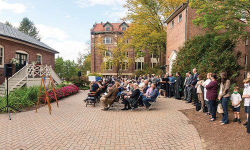 crowd attends presentation behind alumni hall