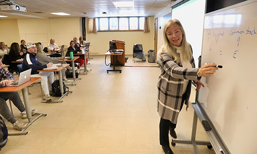 Professor Kelly Lalonde teaching a finance class in Poisson Hall