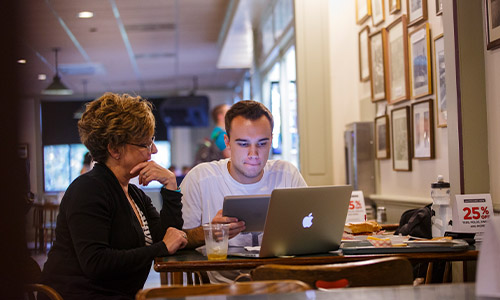 student on a laptop at a table