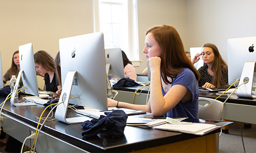students sitting at desktop computers