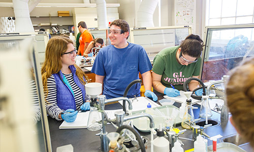 students talking while working on a lab