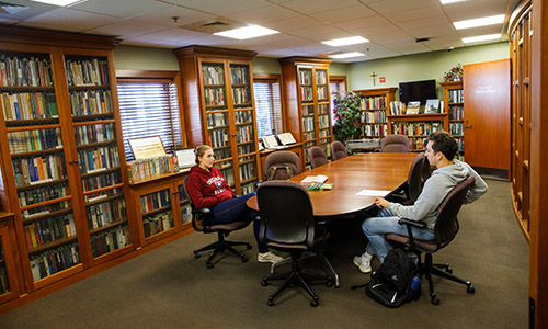 students at a conference table