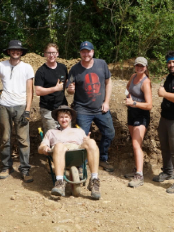 Students pose for a picture at the dig site