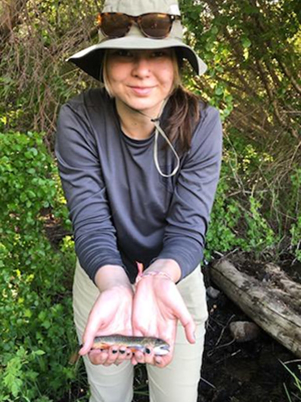Student holding a fish