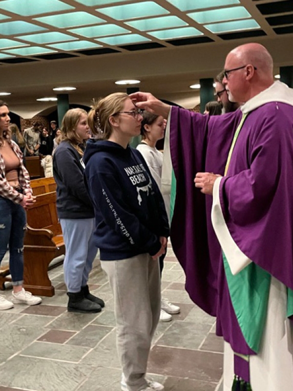student receives blessing in the abbey church