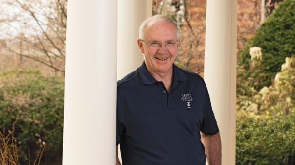 Mike McGuinness '78 poses for a photo in front of Joseph Hall