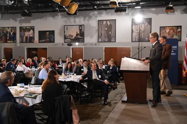 People engaged in discussion at round tables