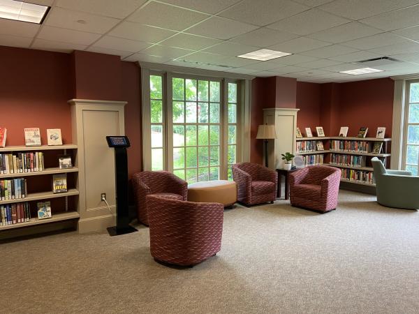 Soft armchairs in the Reading Room grouped around a window near the Leisure Reading collection