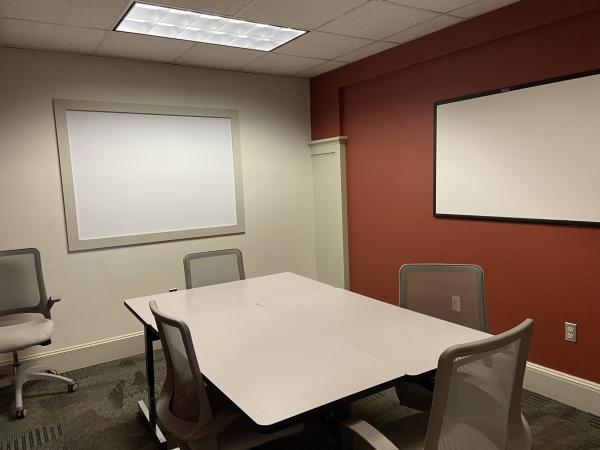 Study Room 1 with large table, 5 chairs, and whiteboard