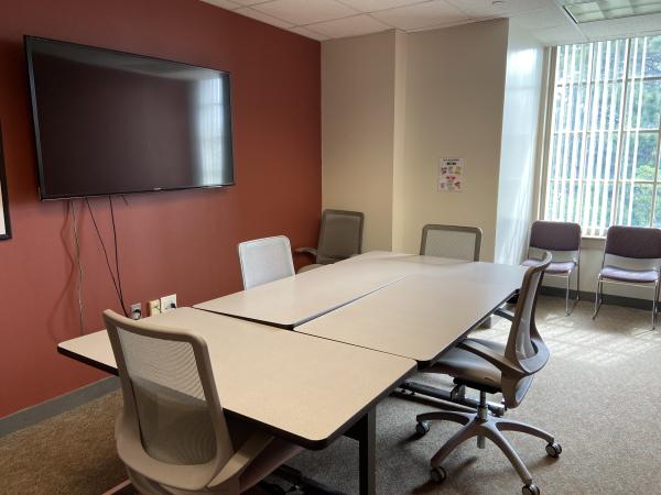 Study Room 3 with large table, 7 chairs, large monitor, whiteboard, and window