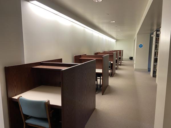 Study carrels along a wall on the upper level