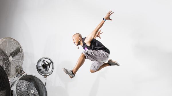 Aaron Tolson jumping in the air in front of fans