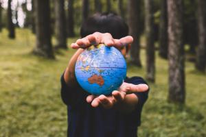 person holding a globe