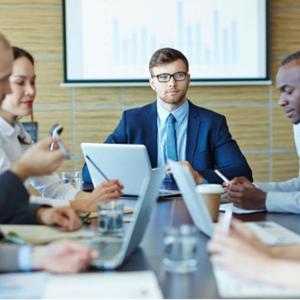 People sitting around a table for a meeting.