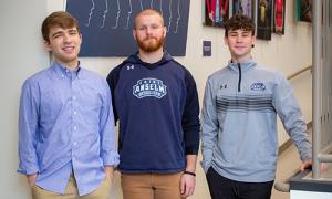 Students stand in front of the mental health exhibit