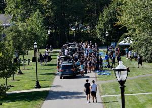 Cars line up as students unpack and move items into dorms