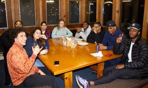 Students chat around a table