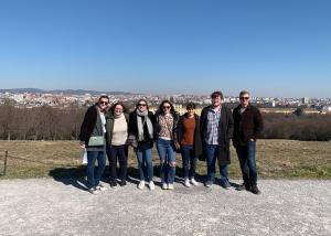 Students stand in front of a landscape in Vienna