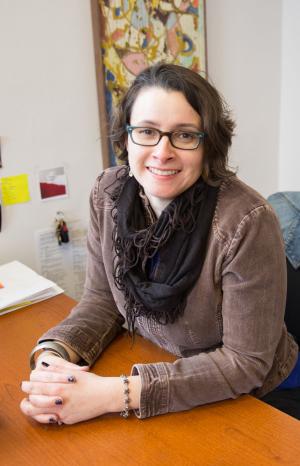 Lindsay Coats sitting at a desk smiling