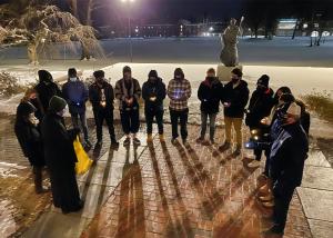 Students and staff hold a vigil on the front steps of Alumni Hall