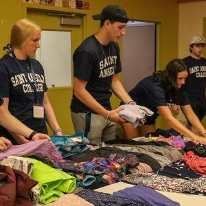 Students sort clothes for charity on their day of service