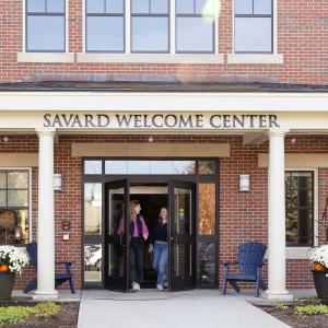 Students walking out of the Savard Welcome Center