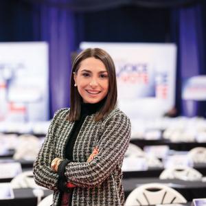 Kelsey Walsh stands in the spin room for the Democratic Debate