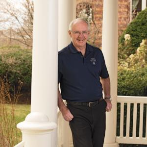 Mike McGuinness '78 poses for a photo in front of Joseph Hall