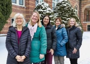 Staff members pose in front of Alumni Hall