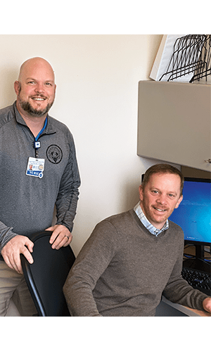 Ryan Gagnon ’97 and Brian Laneau ’98 at a computer
