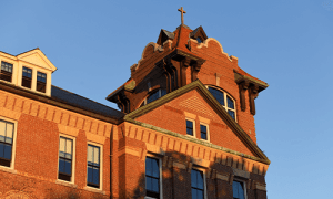 A view of the Alumni Hall bell tower at sunset