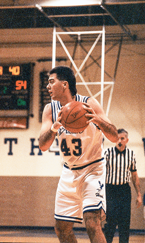 Christopher Rodgers holding a basketball on the court