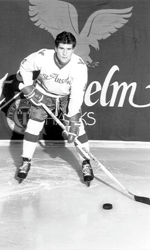 Dan Kelley '86 poses in his hockey uniform on the ice