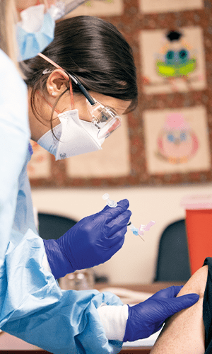 Student nurse prepares to give a shot