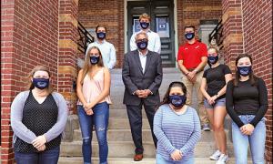President Favazza and students standing on the steps on Alumni Hall in masks