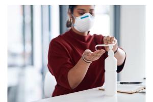 Nurse applying hand sanitizer