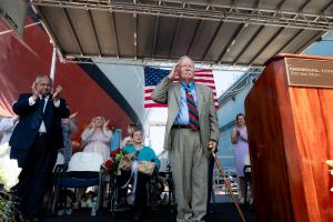 Harvey Barnum Jr. saluting at the commissioning ceremony