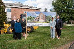 Roger Jean, Francine Jean, Beverly Grappone, Dean Diane Uzarski, and President Joseph Favazza in front of the architectural rendering.
