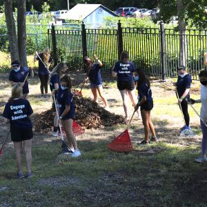 Saint Anselm College students raking leaves during Day of Service