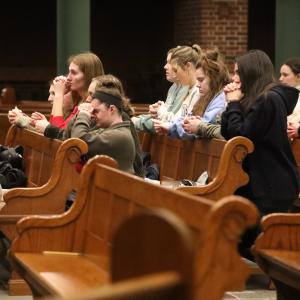 Students praying in pews
