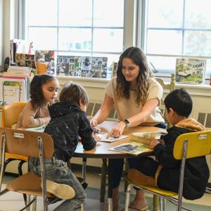 Teacher surrounded by students in the classroom