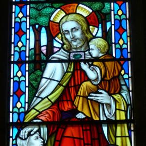 Stain glass Jesus holding a child