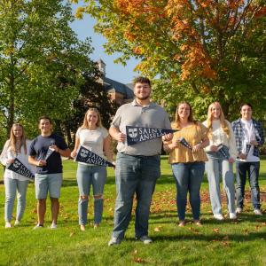 Saint Anselm students standing on the quad with mini class banners